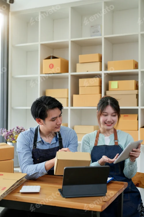 Preview: startup small business owner working with tablet at workplace. freelance man and woman seller check