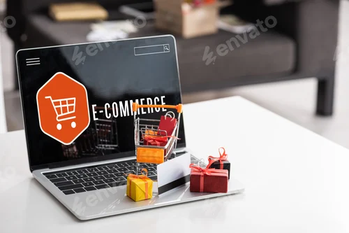 Preview: Toy gift boxes and credit card on laptop with e-commerce lettering on table